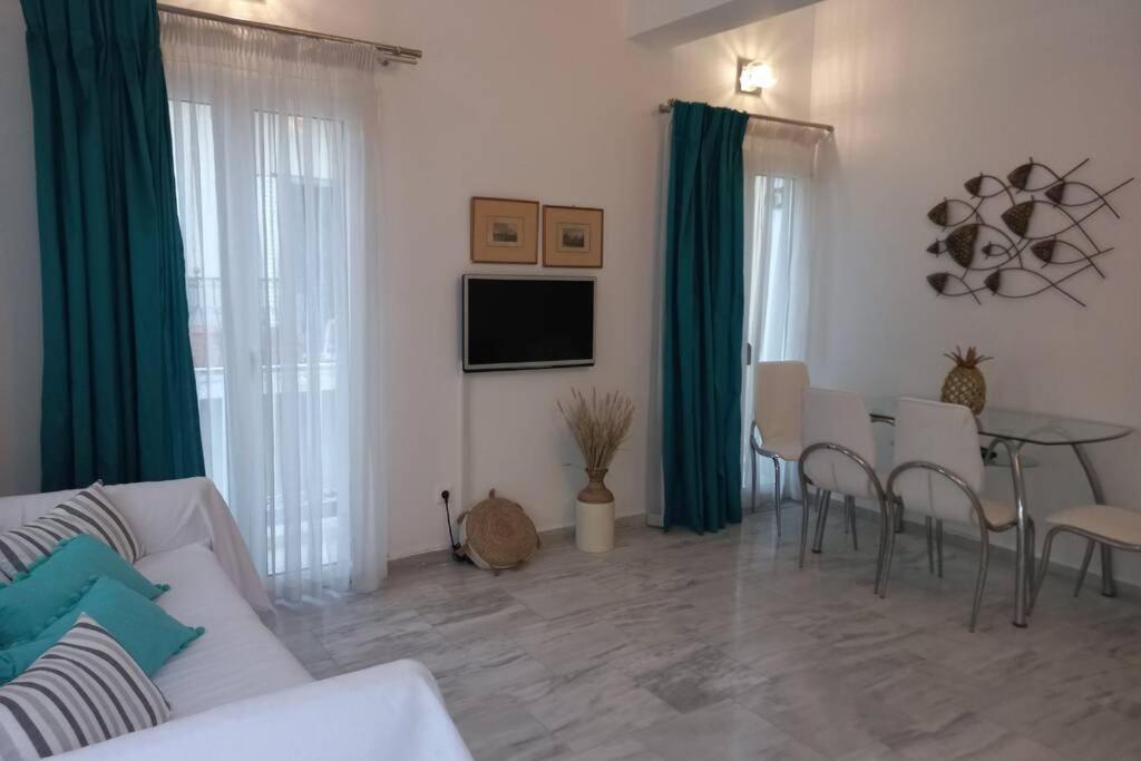 a living room with a couch and a table with chairs at Casa Bianca in Kalymnos