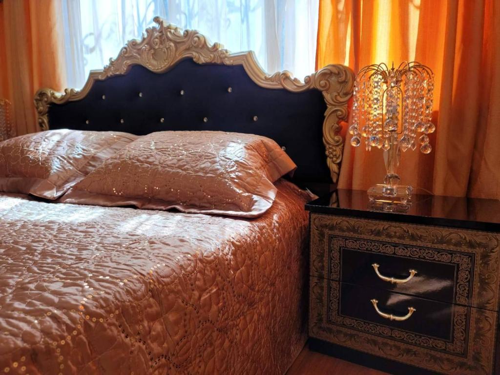 a bedroom with a bed and a nightstand with a bed sidx sidx at Apartment on Lenina Street in Chornomorsk