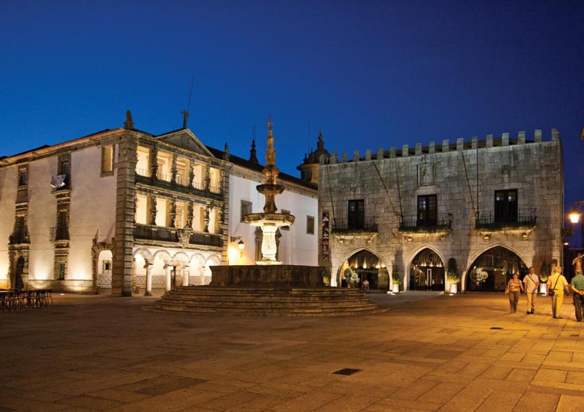 a large building with a large clock on the side of it at Enjoy Viana - Guest House in Viana do Castelo