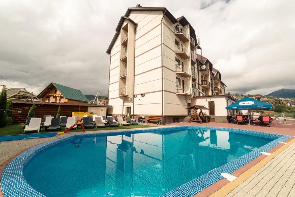 einem großen Pool vor einem Gebäude in der Unterkunft Villa Leku SPA Resort in Bukowel