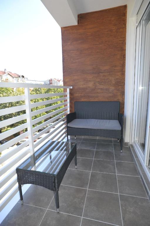 a balcony with a bench and a window at Twins Apartments in Čačak