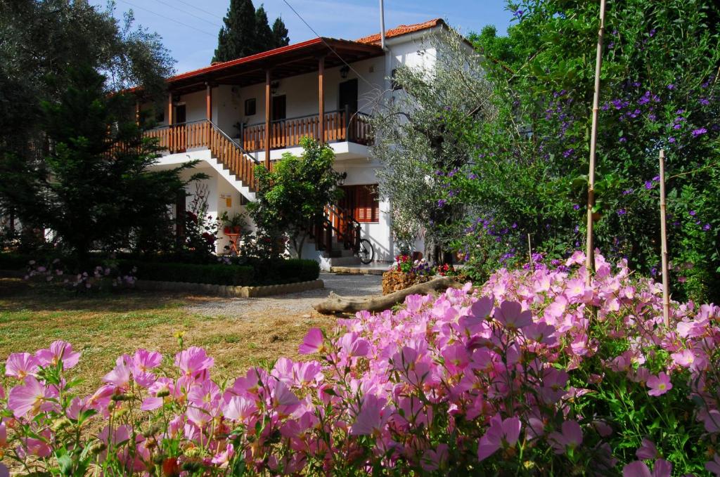 a house with pink flowers in front of it at Vergonis Studios in Koropi