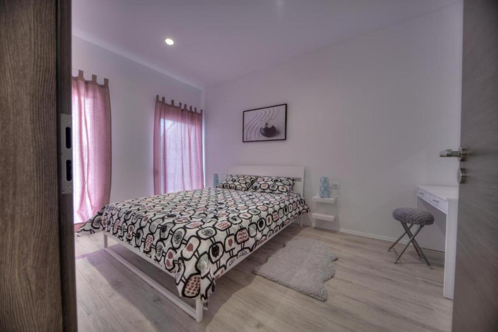 a bedroom with a bed with a black and white comforter at Apartments Estelle in Pula
