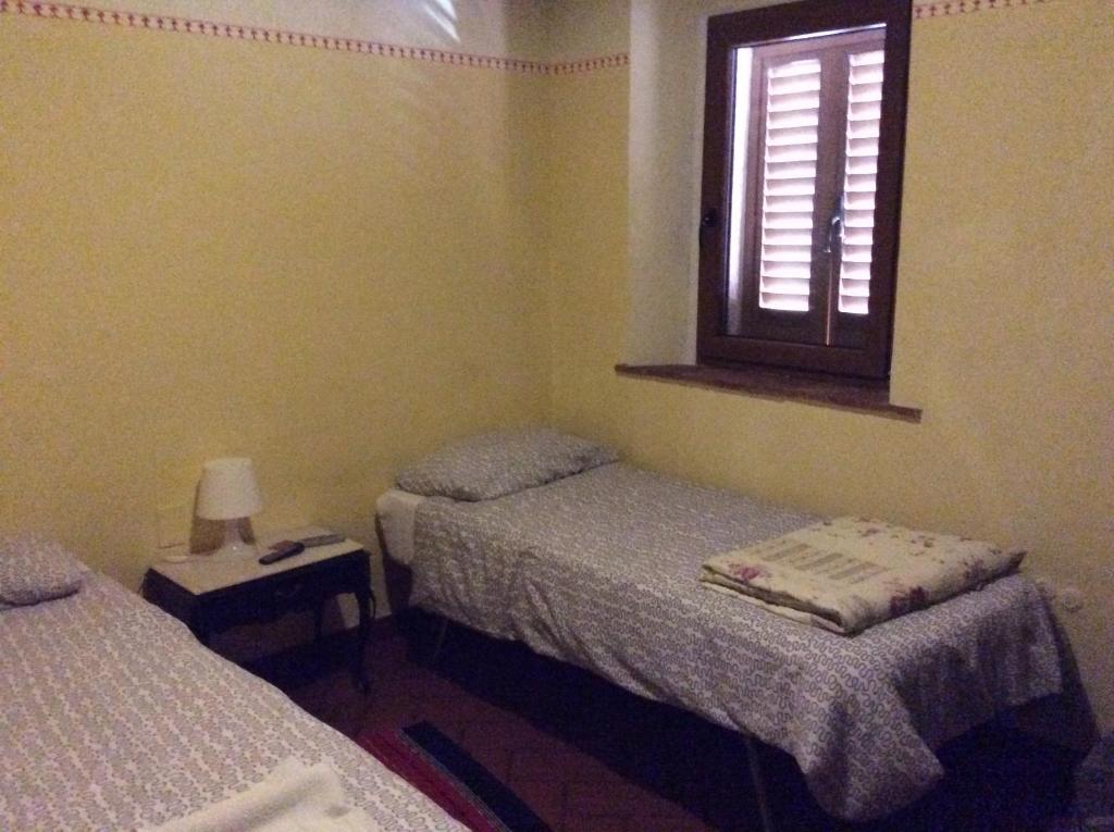 Łóżko lub łóżka w pokoju w obiekcie B&B e Locazioni Turistiche Antico Borgo Toscano