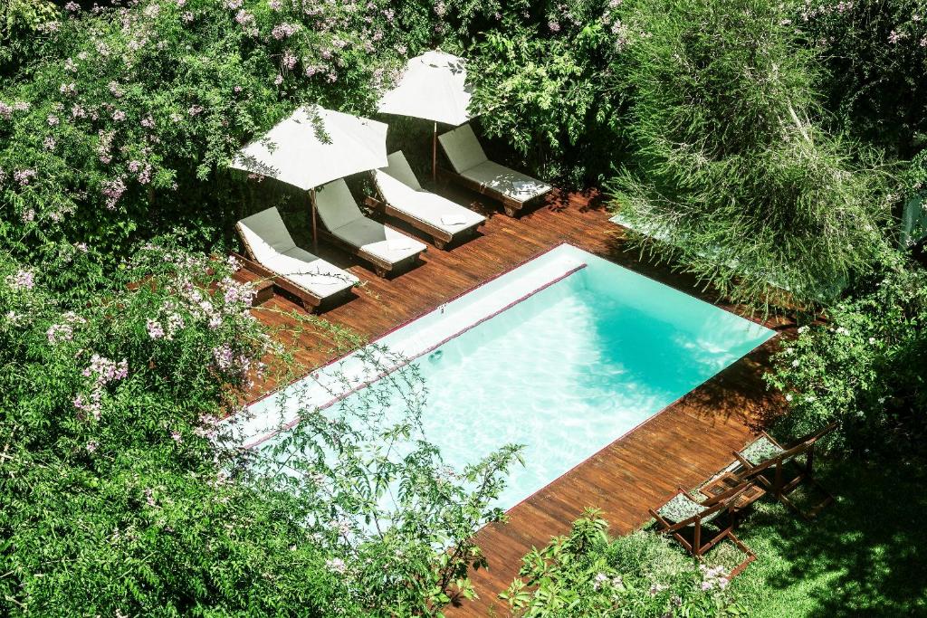 an overhead view of a swimming pool with lounge chairs at Home Hotel in Buenos Aires