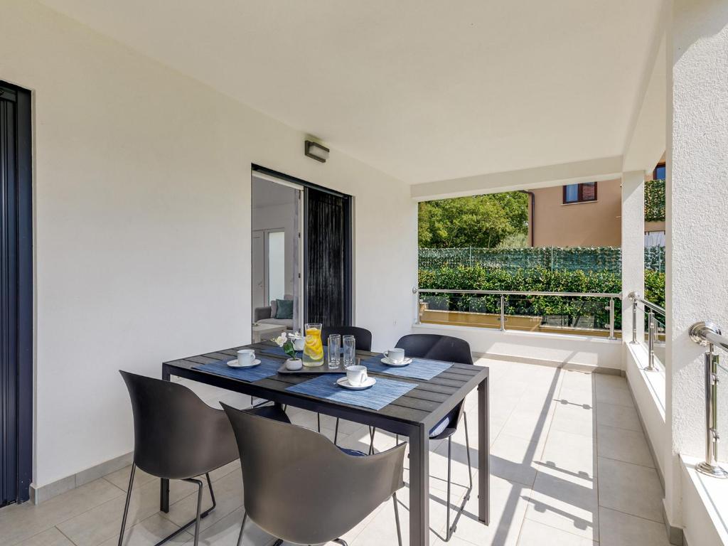 a dining room with a table and chairs at Apartment Aria in Poreč