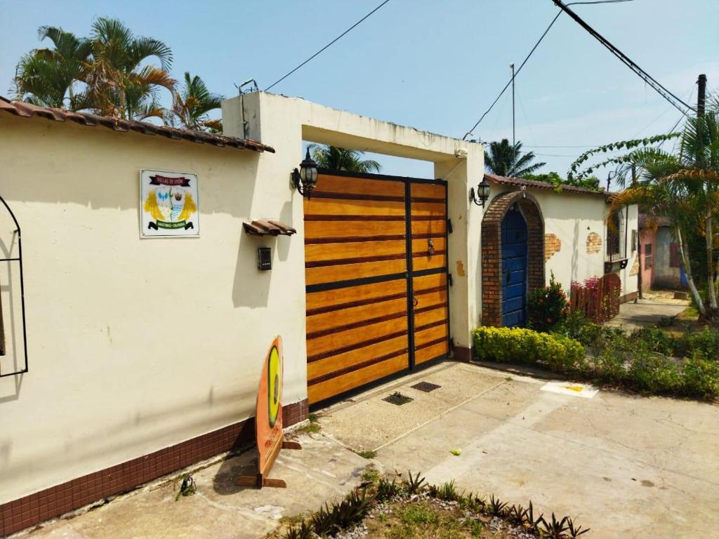 una puerta de madera de garaje en una casa blanca en Villas de León en Leticia