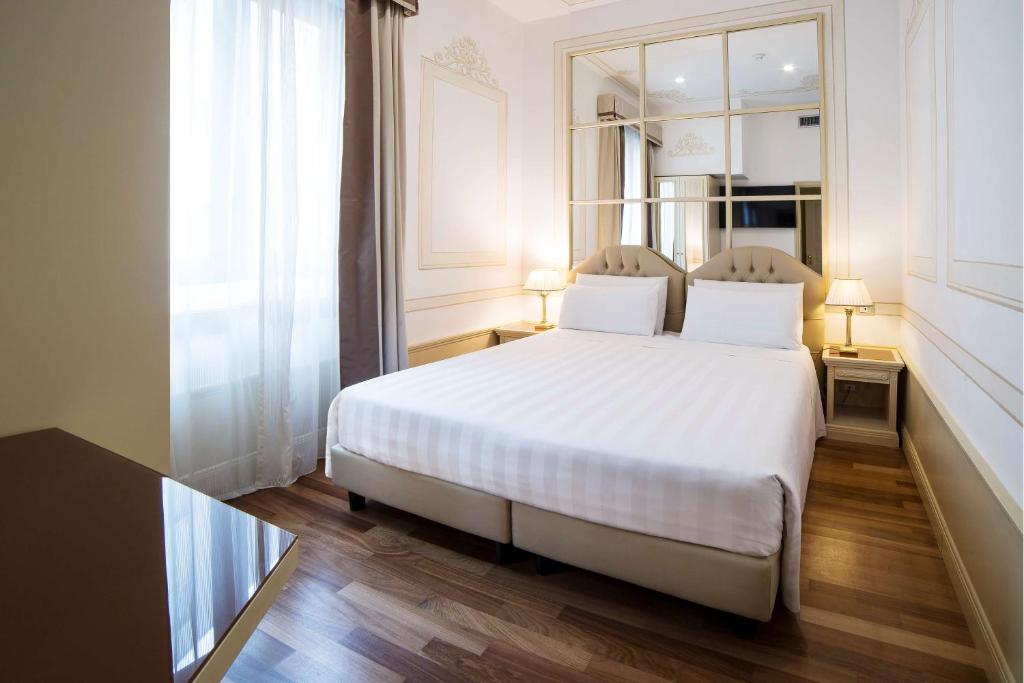 Postel nebo postele na pokoji v ubytování Radisson Blu GHR Rome