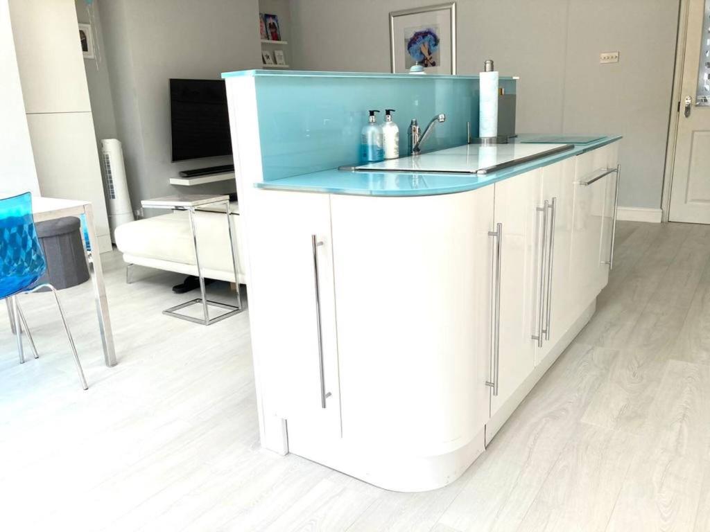 a kitchen with a blue counter top in a room at 8 Guests House Wow in Coventry