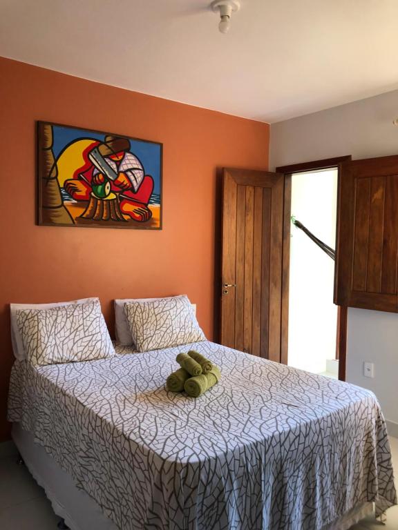 a bedroom with a bed with a stuffed animal on it at Pousada Lagoa Flat in Morro de São Paulo