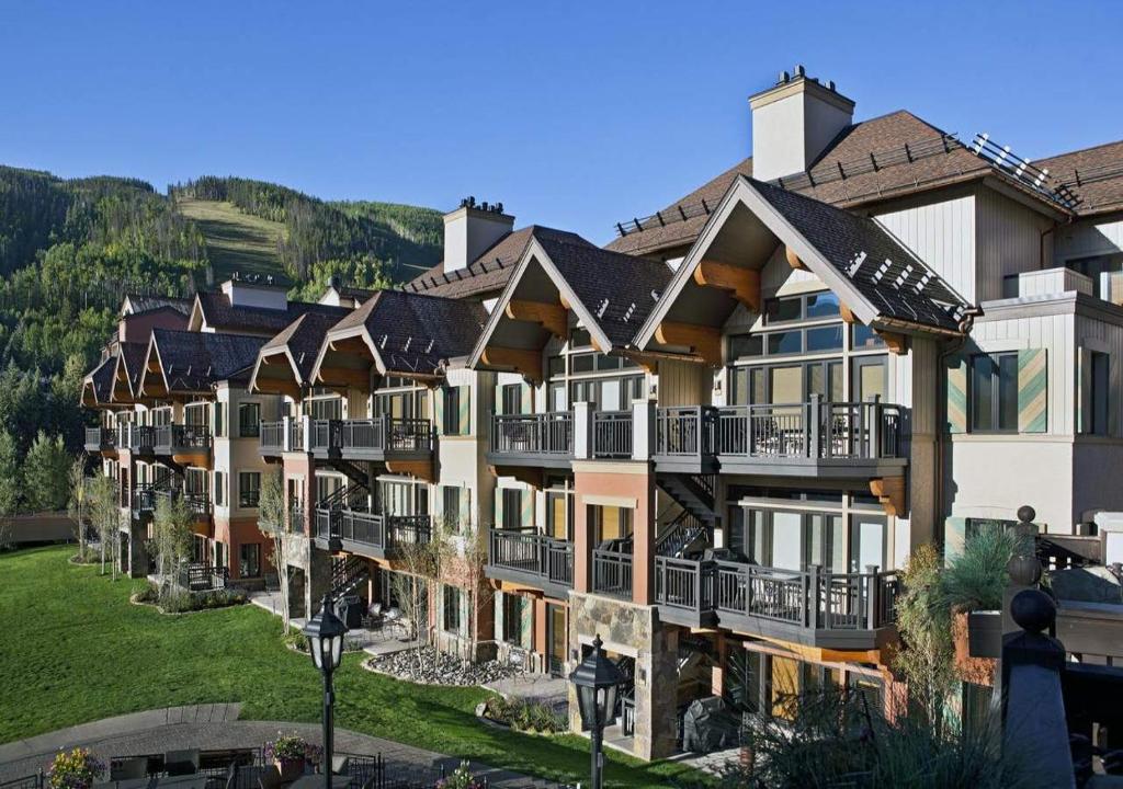 an image of a resort with mountains in the background at Lion Square Lodge Condos by TO in Vail