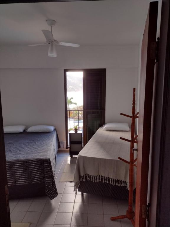Cama ou camas em um quarto em PÉ NA AREIA - Frente a Piscina e ao Mar