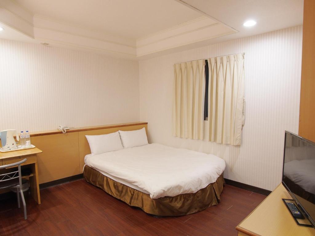 Postel nebo postele na pokoji v ubytování Yi Pin Yuan Hotel
