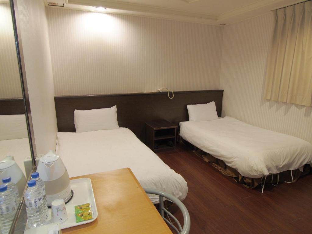 Postel nebo postele na pokoji v ubytování Yi Pin Yuan Hotel