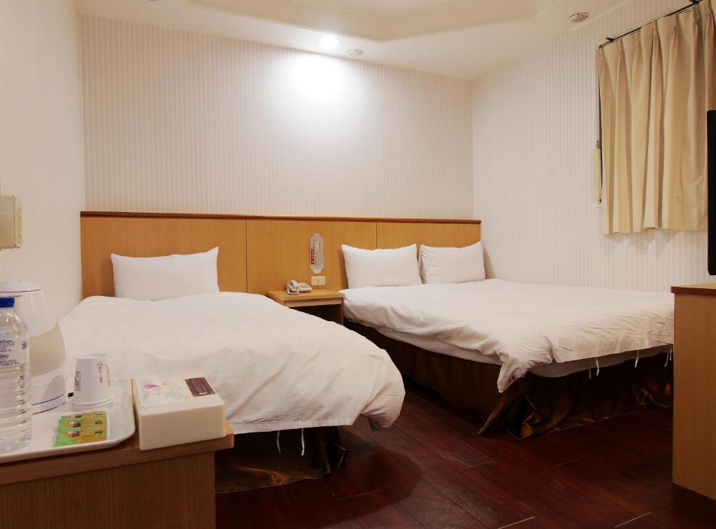 Postel nebo postele na pokoji v ubytování Yi Pin Yuan Hotel