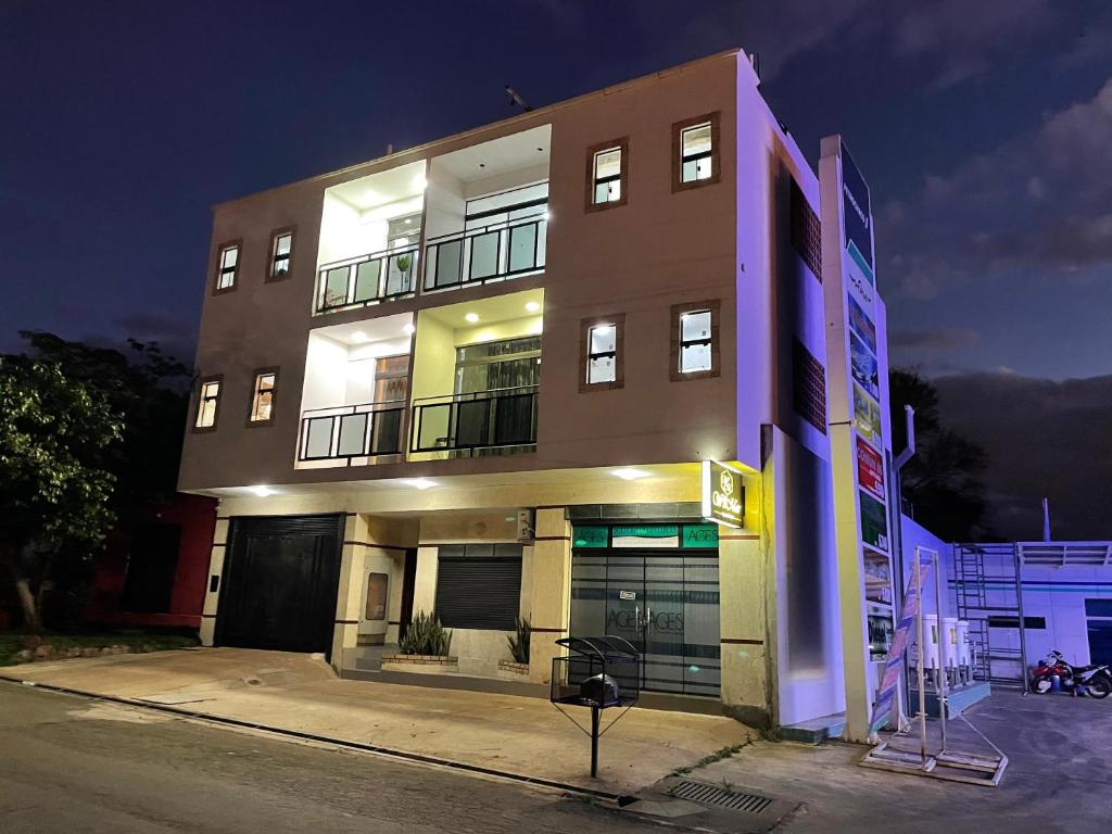 a tall building with lights on the side of it at WilMar Apart Hotel in Encarnación
