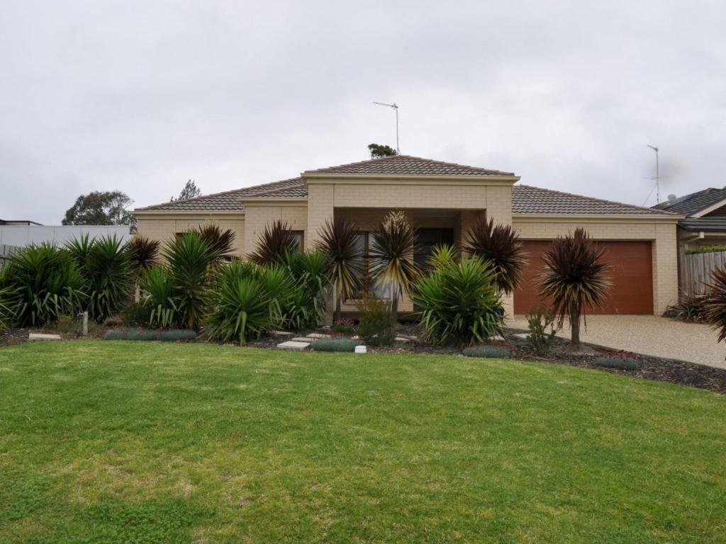 a house with a lawn in front of it at The Haven in Inverloch