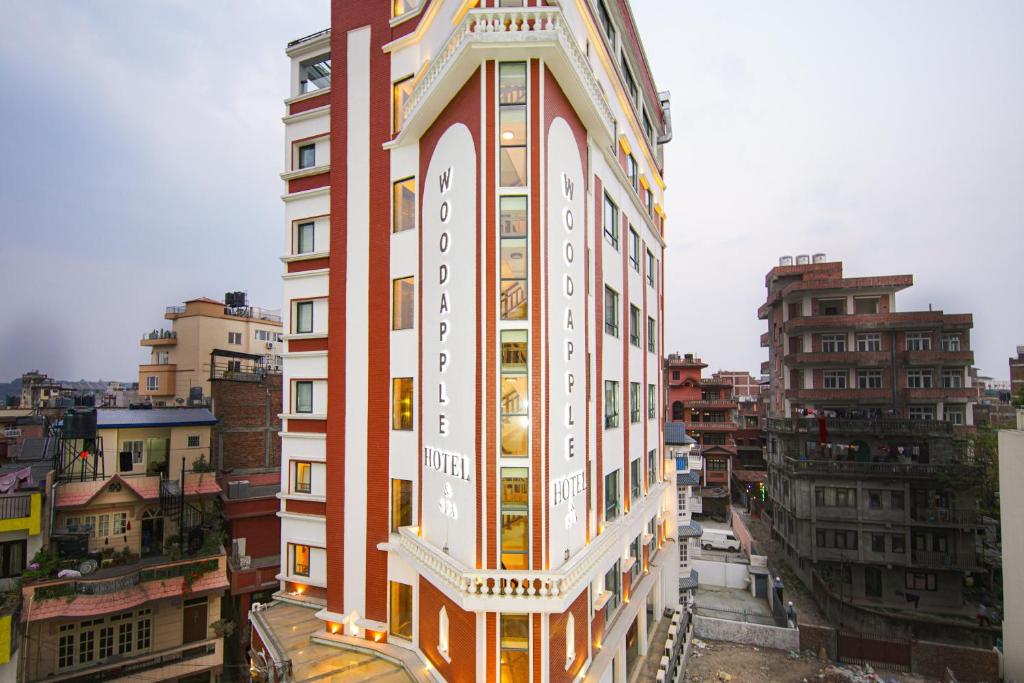 a tall building in the middle of a city at Woodapple Hotel and Spa in Kathmandu