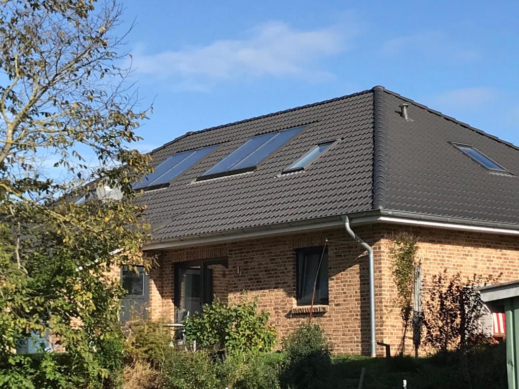un toit d'une maison avec des panneaux solaires dans l'établissement Zum Eulennest, à Rantrum