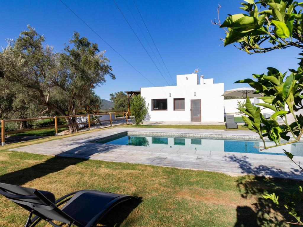 a villa with a pool and a house at Cortijo villa maroma in Órgiva