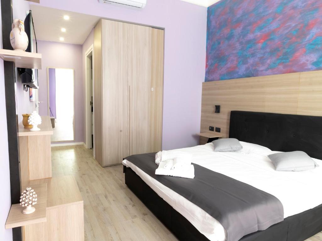 Rúm í herbergi á Mini Hotel Wf2 Caltagirone