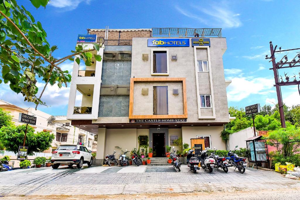 a building with motorcycles parked in front of it at FabHotel The Castle Homestay in Jaipur