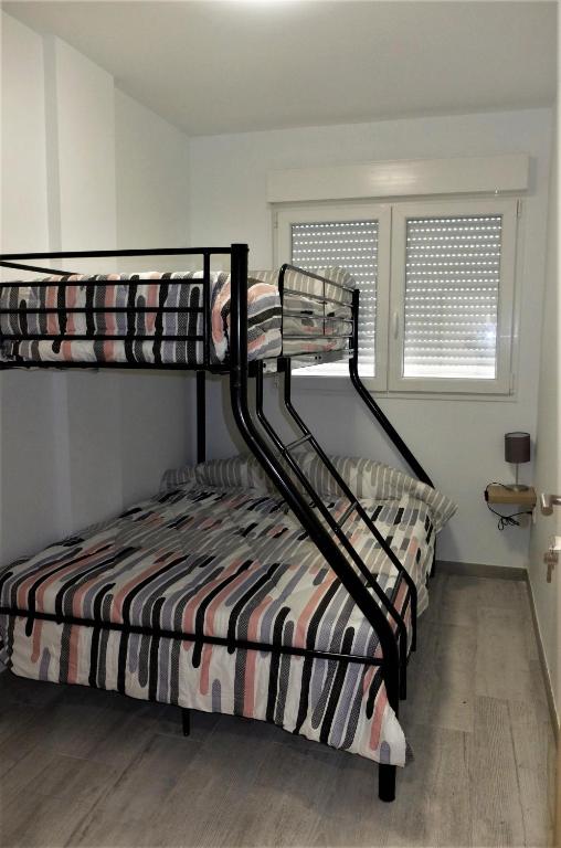 A bed or beds in a room at Gegant de Pedra Apartaments