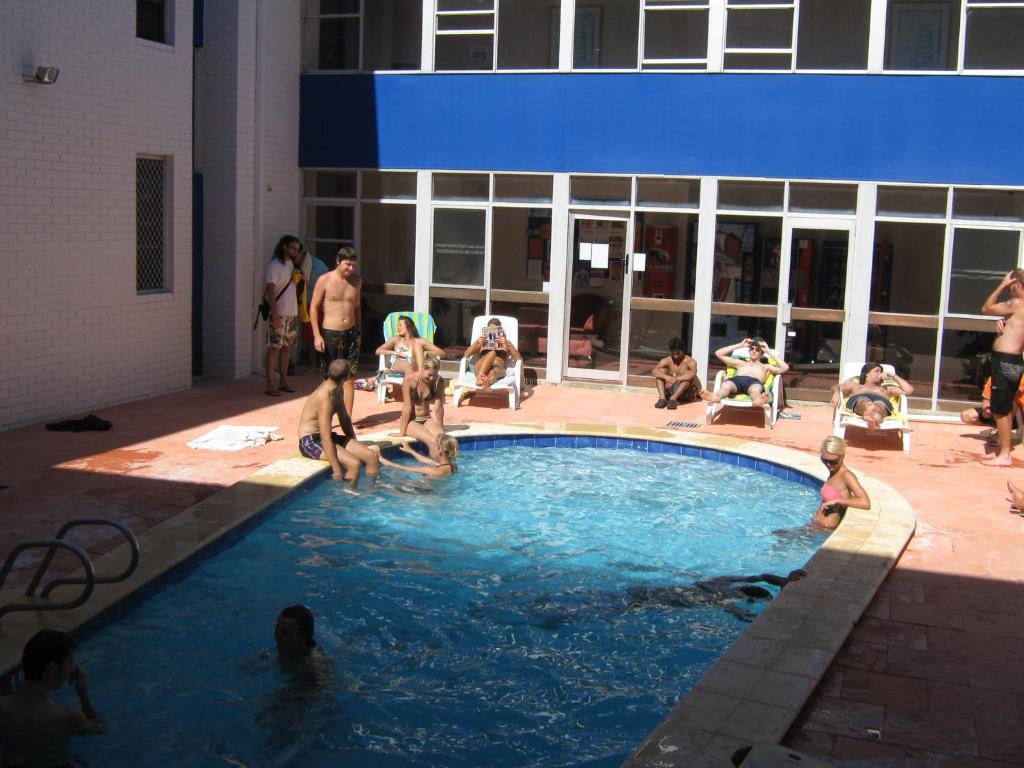 a swimming pool with a group of people in it at Beatty Lodge in Perth