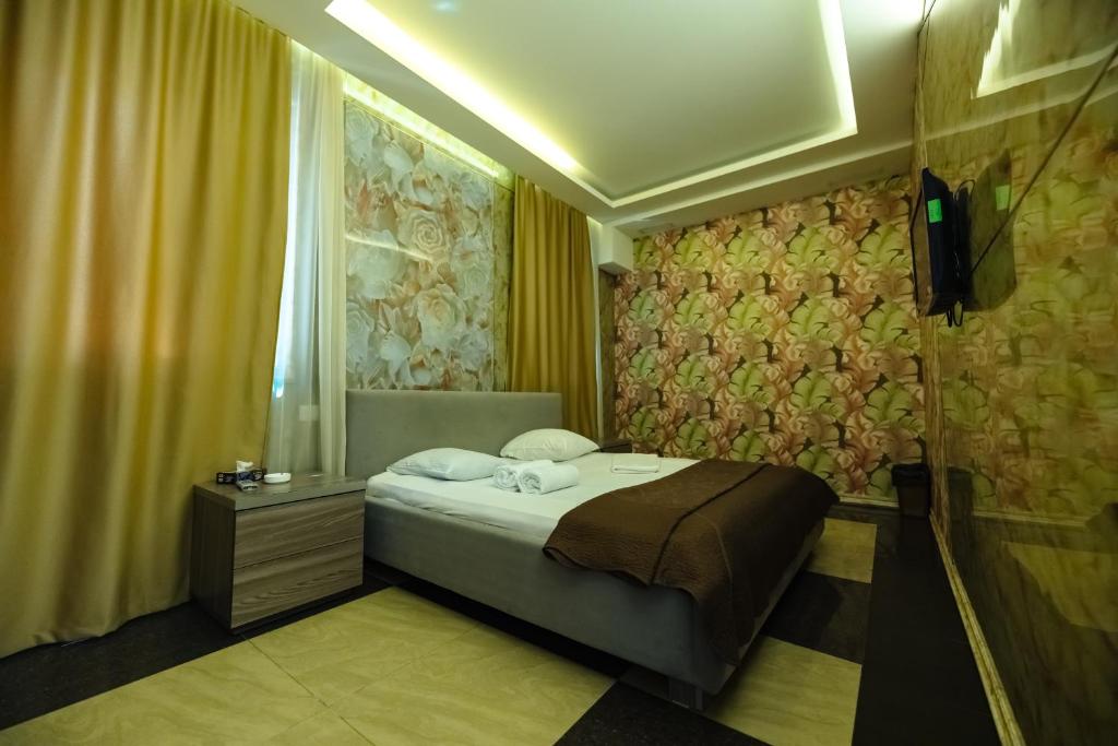 Postel nebo postele na pokoji v ubytování GOLDEN SECONDS Hotel