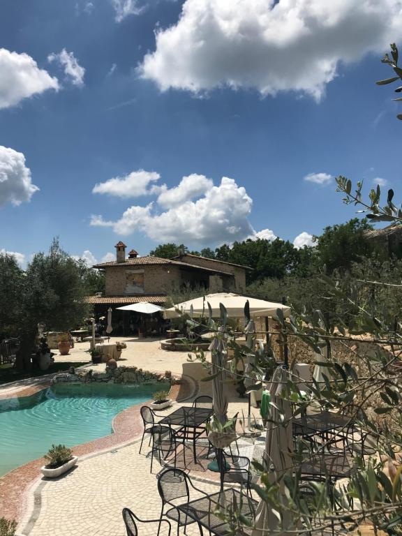 a resort with a pool and chairs and a building at Agriturismo Le Faeta in Arpino