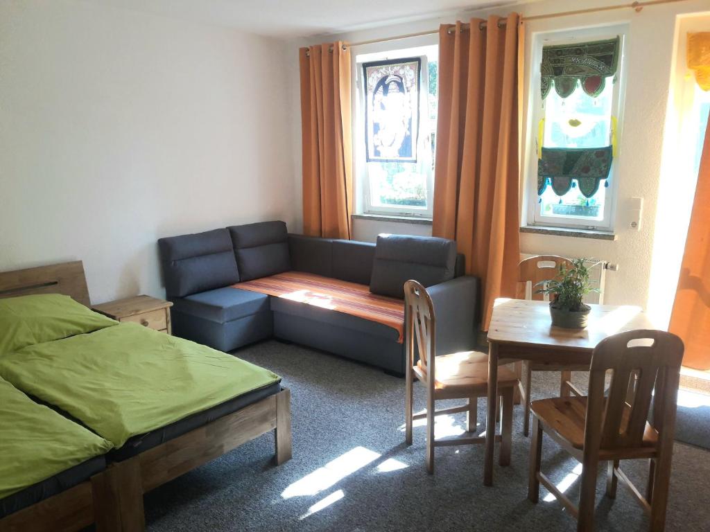 um quarto com uma cama, uma mesa e um sofá em Birkenhof Ashram Lakshmi Zimmer em Hartau