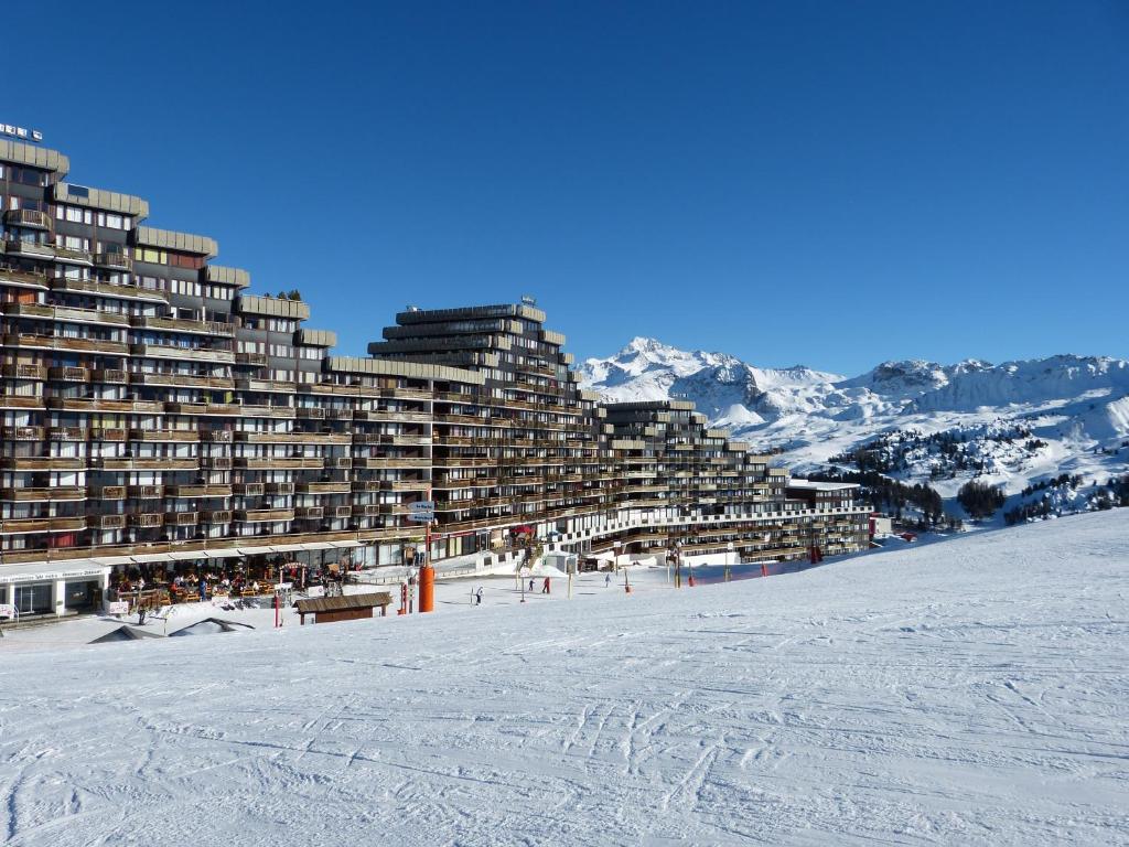 a ski resort in the mountains with snow on the ground at travelski home select - Vue Mont Blanc in Aime-La Plagne