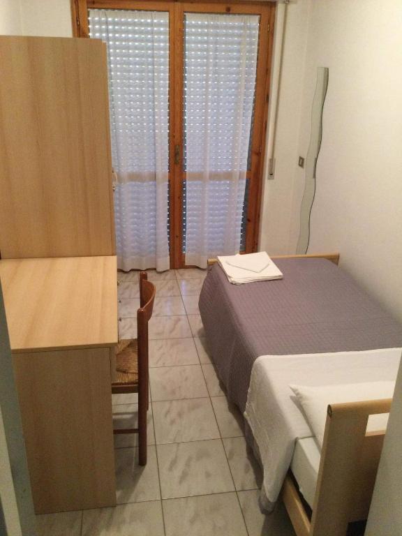 Łóżko lub łóżka w pokoju w obiekcie Appartamento Belvedere