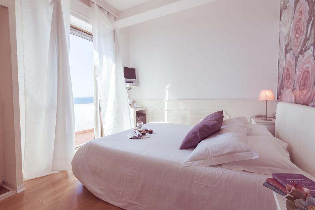 Postel nebo postele na pokoji v ubytování Piccolo Mondo Hotel