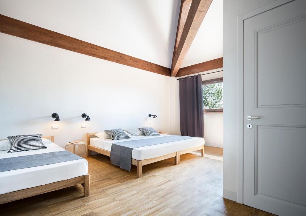 Postel nebo postele na pokoji v ubytování SCUDERIA LA COLOMBERA