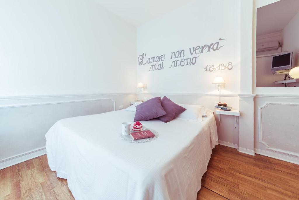 Postel nebo postele na pokoji v ubytování Piccolo Mondo Hotel