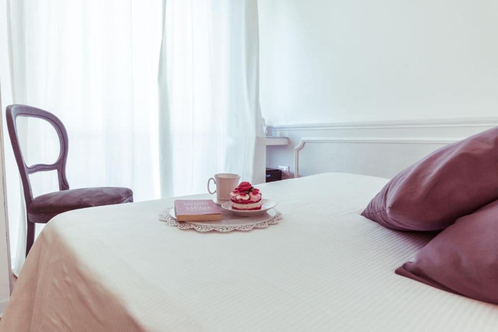 Postel nebo postele na pokoji v ubytování Piccolo Mondo Hotel