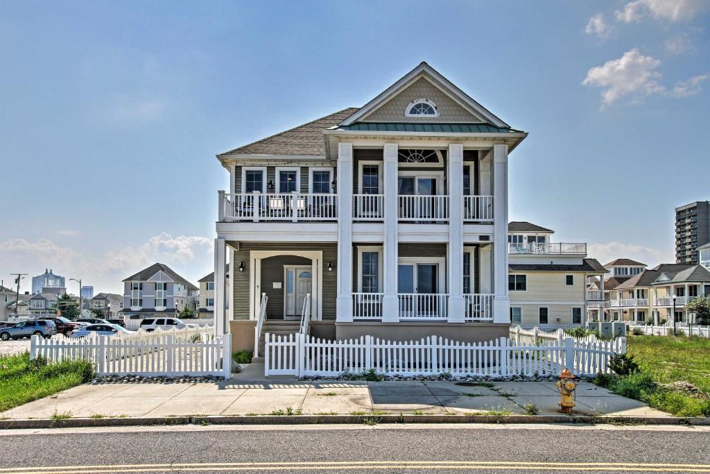 a house with a white fence in front of it at Idyllic Oceanfront Home on Atlantic City Boardwalk in Atlantic City