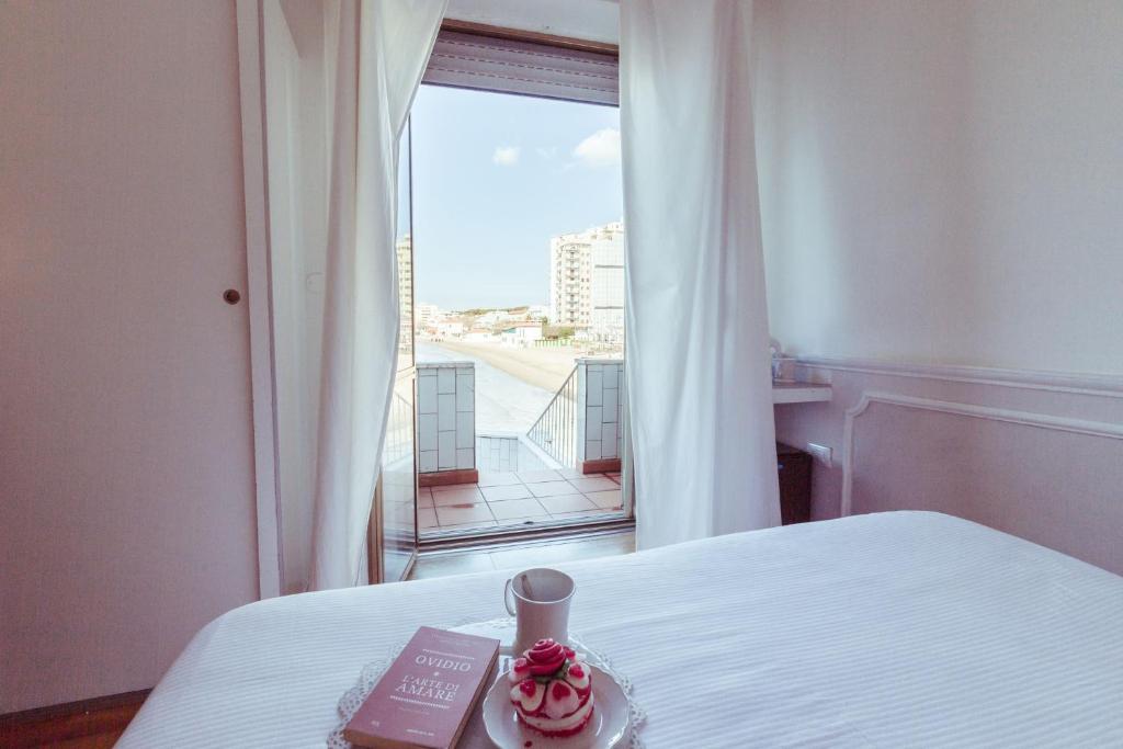 Postel nebo postele na pokoji v ubytování Piccolo Mondo Hotel