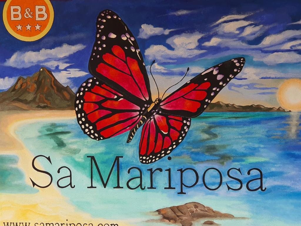 a book with a monarch butterfly on the cover at Sa Mariposa in Muravera