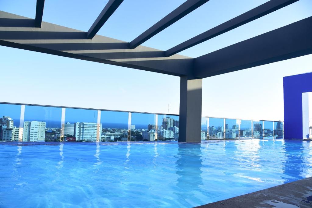 a swimming pool with a view of the city at Apartamento N1401 Downtown Santo Domingo in Santo Domingo