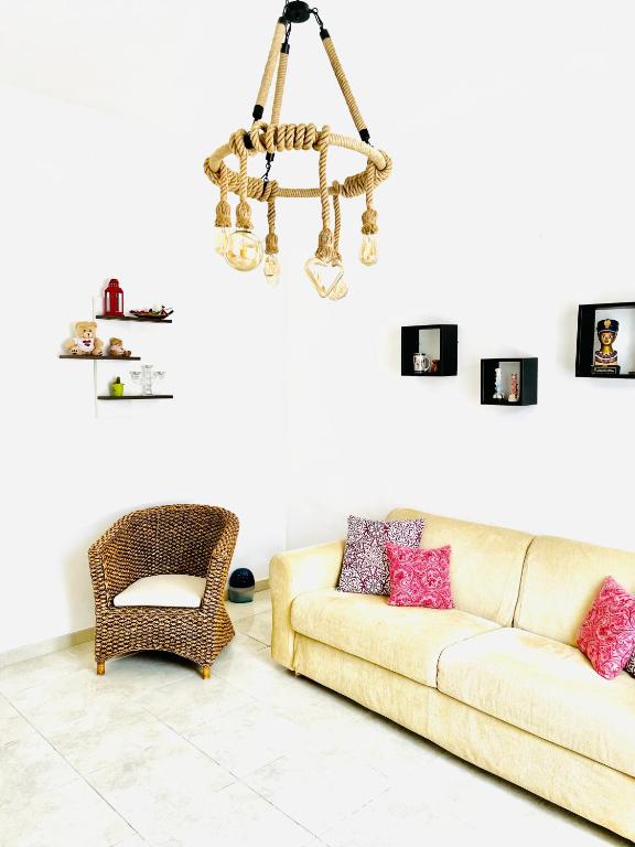 a living room with a couch and a chandelier at Relax House in Bari