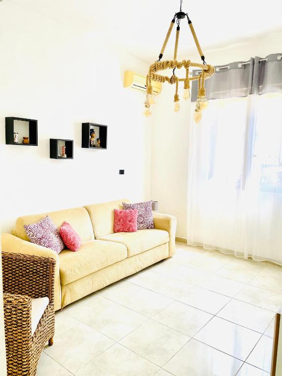 a living room with a couch and a chandelier at Relax House in Bari
