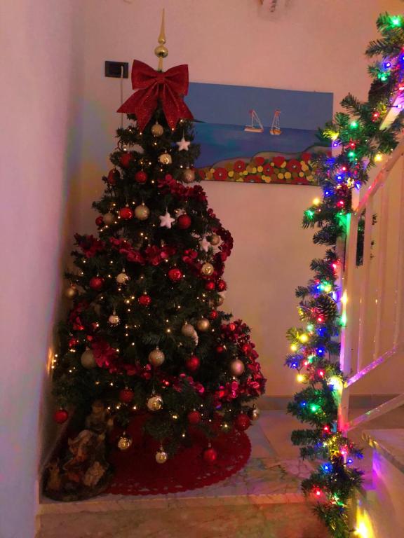 a christmas tree in a room with christmas lights at Relax House in Bari