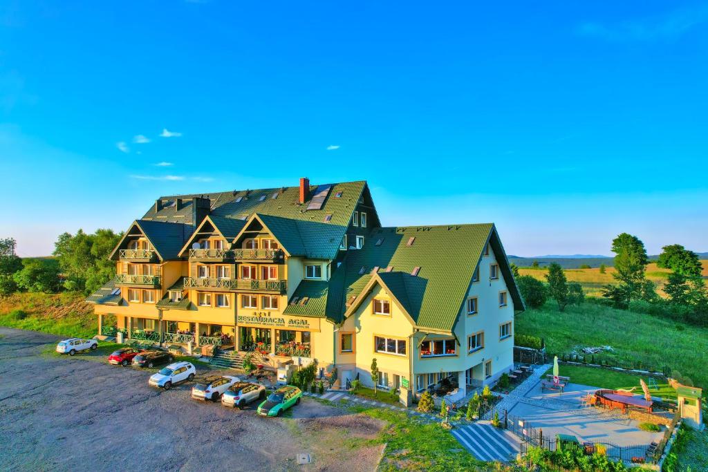 a large house with cars parked in front of it at Agal Zieleniec in Zieleniec