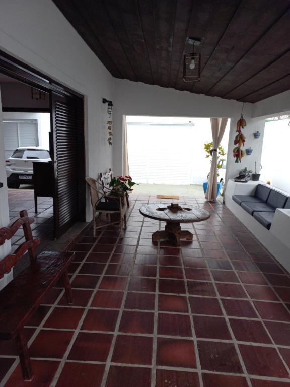 een woonkamer met een bank en een tafel bij Pousada Sol da Manhã in Guarujá