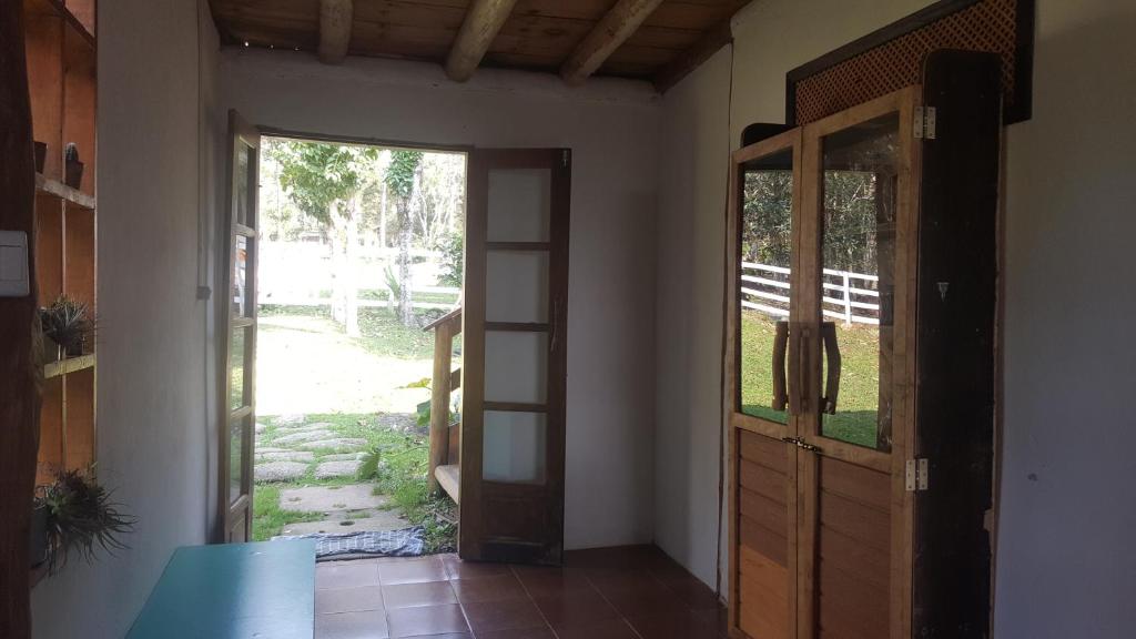 an open door to a room with a door at Gran Camping Cabanas da Fazenda in Visconde De Maua