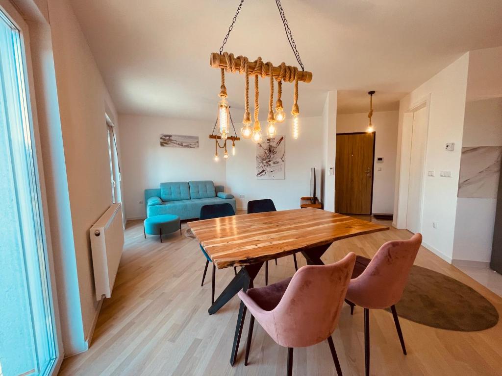 a dining room with a wooden table and chairs at Apartment 7 in Sarajevo