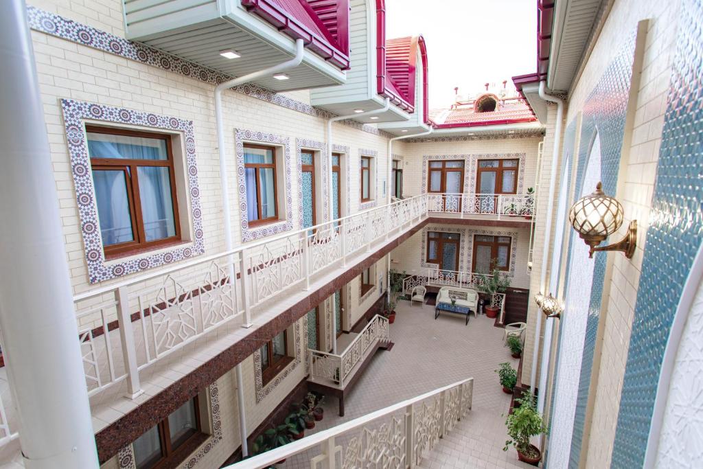 an empty hallway of an old building with windows at Registon Saroy Hotel in Samarkand