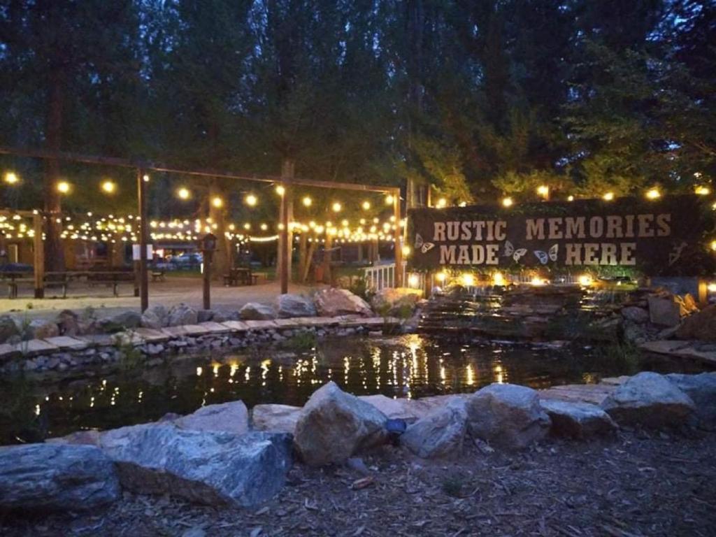 a building with lights and a pond at night at Grey Squirrel Resort in Big Bear Lake